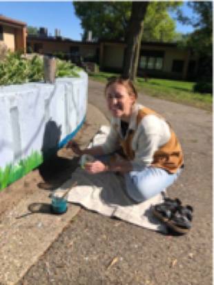 student detailing grass on Shawmut Hills sycamore circle mural
